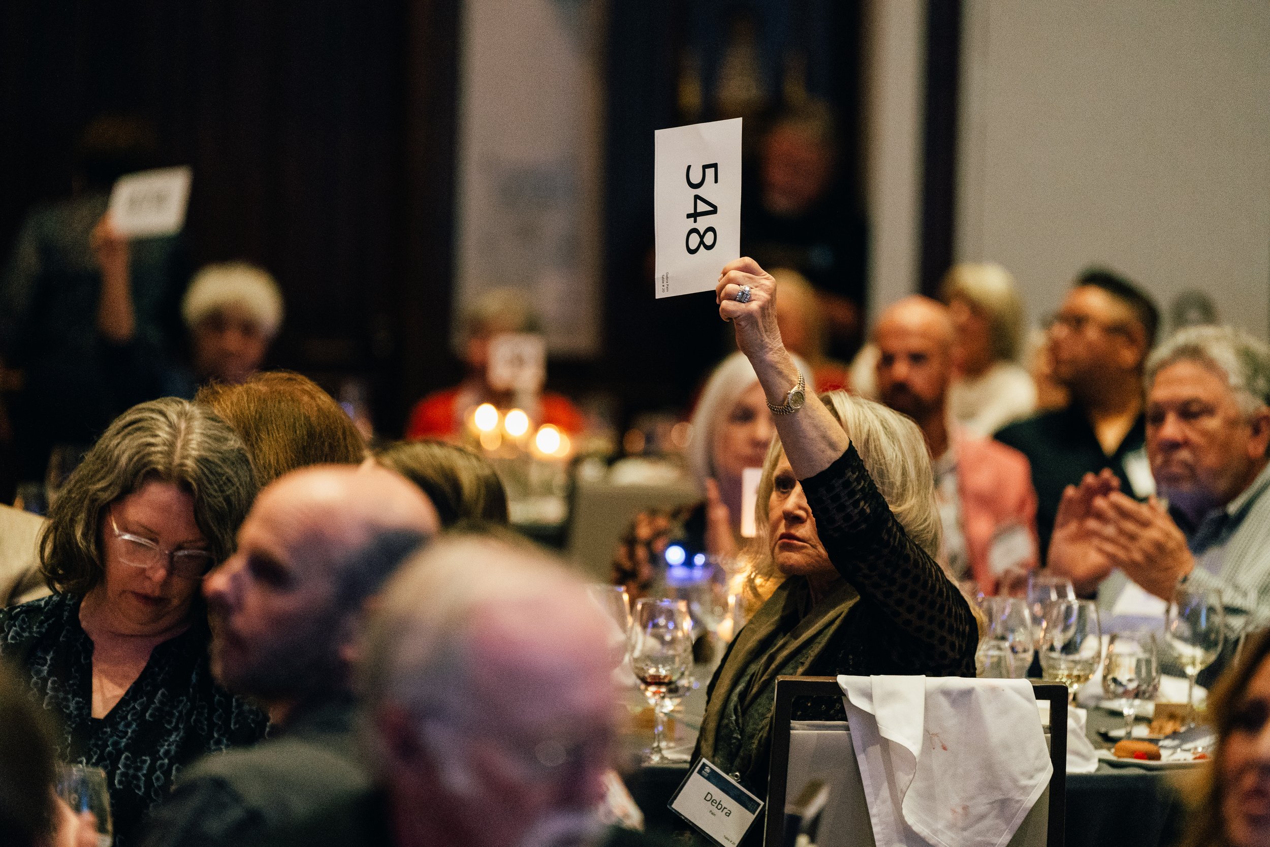 Speaker presenting at a podium with an H&R Block branded backdrop on stage
